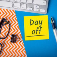 Day Off memo on office workplace. Holiday Announcement Day Off memo on office workplace. Holiday Announcement