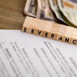 Severance Pay concept with agreement document on wooden board
