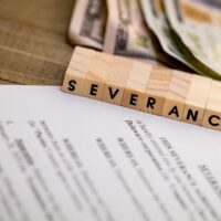 Severance Pay concept with agreement document on wooden board Severance Pay concept with agreement document on wooden board