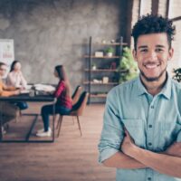 Portrait of nice attractive content cheerful guy shark hr director executive manager wearing blue shirt folded arms career development table at industrial loft interior workplace workstation