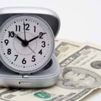 clock and money (dollars) clock and money (dollars)