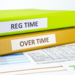 Regular time and Over time words on labels, document binders place on employee time sheets