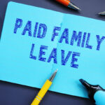 Business concept meaning Paid Family Leave with sign on the sheet.