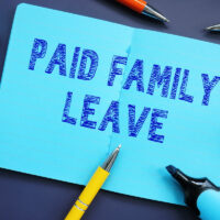 Business concept meaning Paid Family Leave with sign on the sheet.