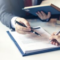Lawyer pointing to the form signing of the contract agreement. Lawyer pointing to the form signing of the contract agreement.
