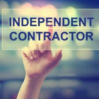 Independent Contractor concept with hand pressing a button Independent Contractor concept with hand pressing a button